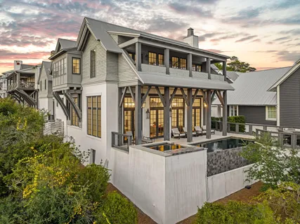 a front view of a house with porch and furniture