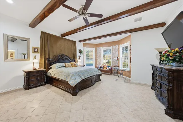 a bedroom with a bed couch and windows