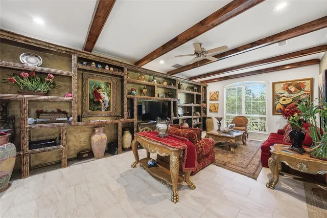 a bedroom with furniture and a large window