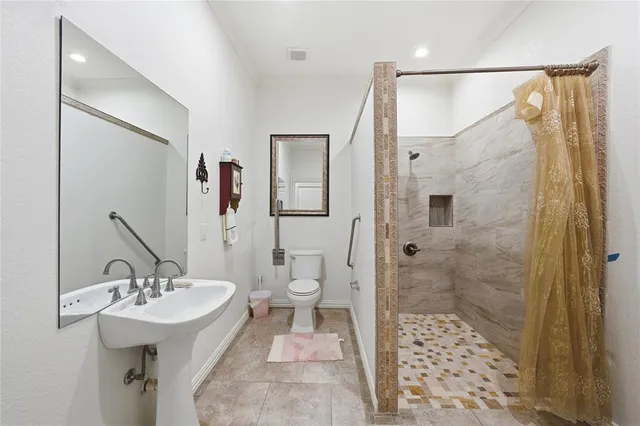 a bathroom with a sink toilet and shower