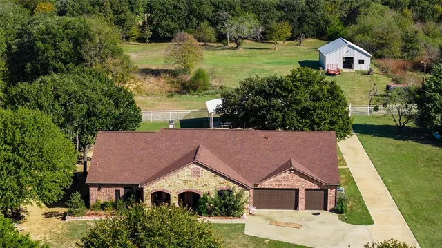 an aerial view of house with yard swimming pool and outdoor seating
