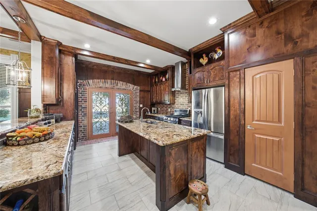 a kitchen with stainless steel appliances granite countertop a stove a refrigerator and a oven