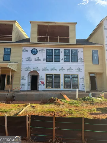 a view of a house with swimming pool and sitting area