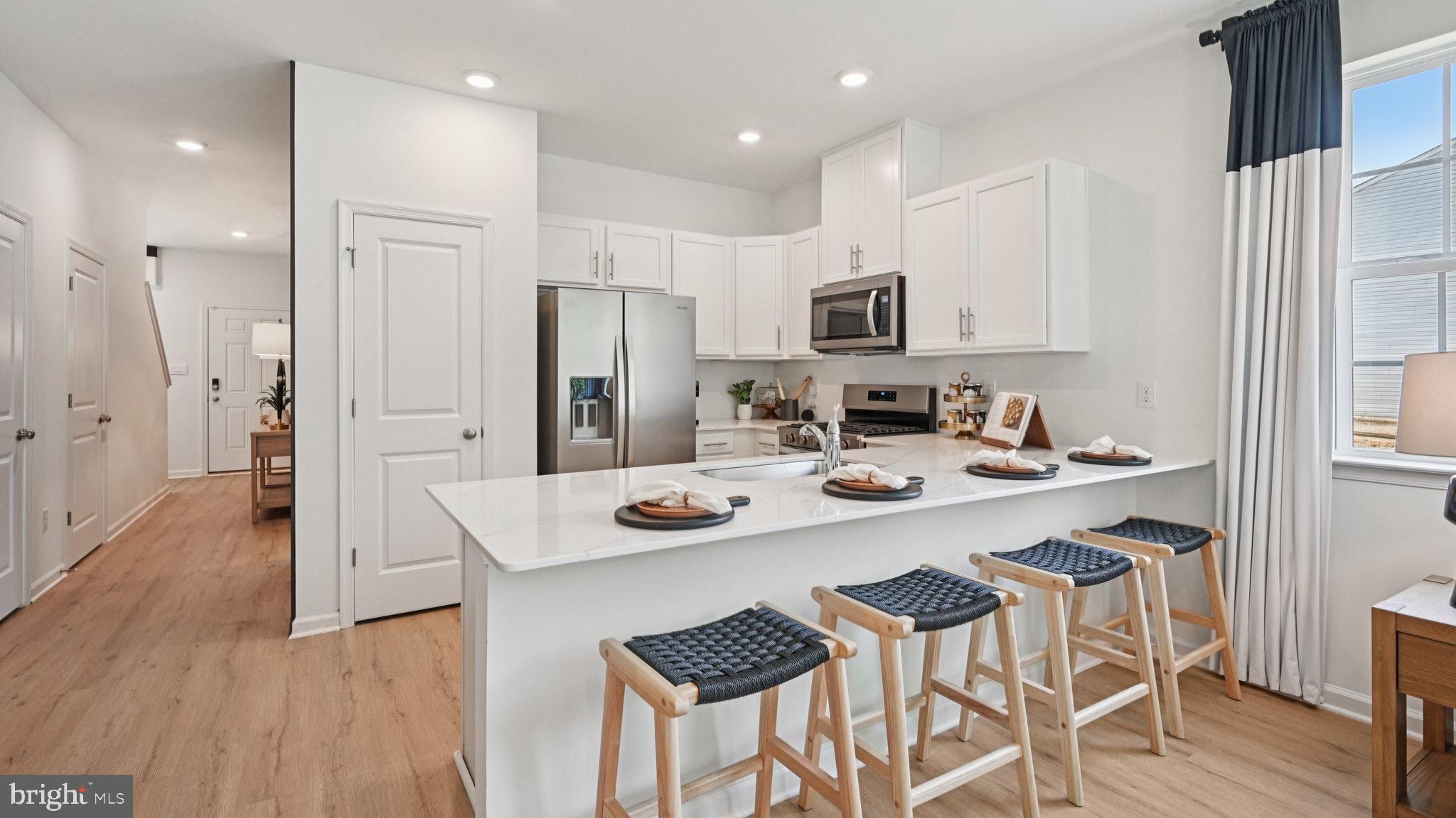 3 Whaler Drive Runnemede, NJ 08078 - Photo 14 of 48 a kitchen with stainless steel appliances kitchen island granite countertop a kitchen island a stove a table and chairs