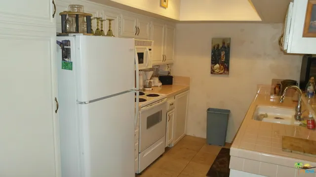 a kitchen with a refrigerator a stove top oven a sink and dishwasher