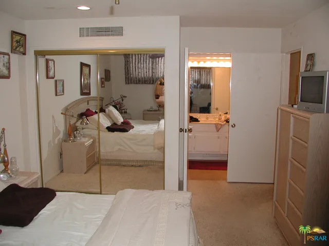 a bedroom with a bed and a view of bathroom