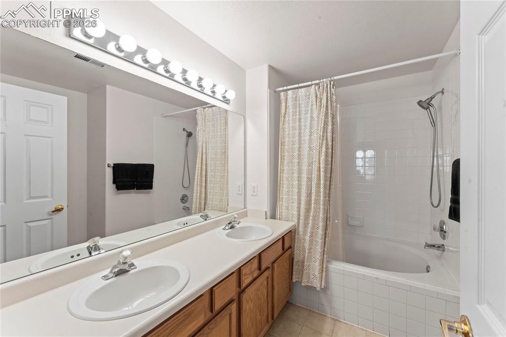 3976 Riviera Grove, Unit 203 Colorado Springs, CO 80922 - Photo 37 of 45 a bathroom with a sink double vanity granite tub and shower