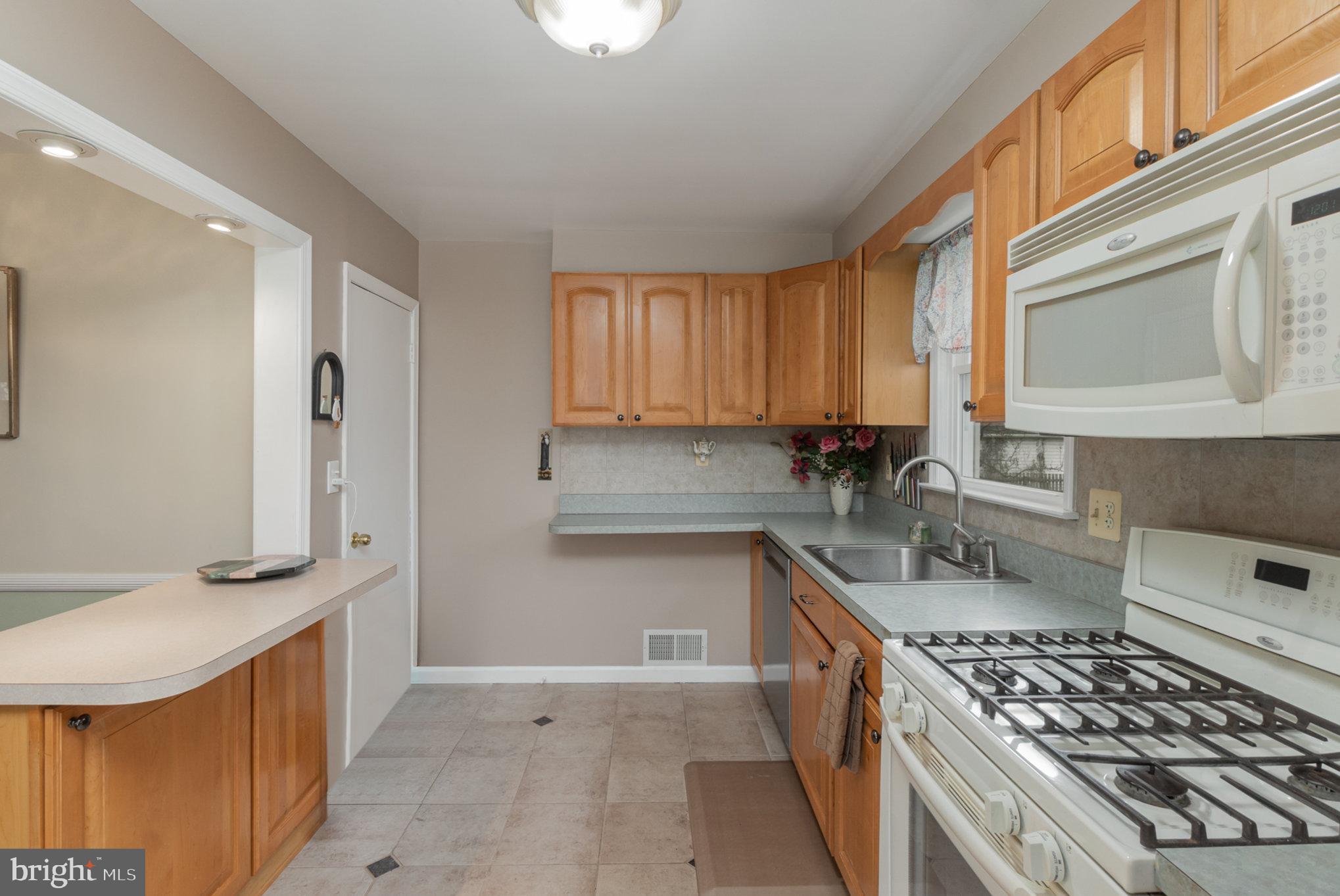 1406 Shefford Road Baltimore, MD 21239 - Photo 3 of 33 a kitchen with stainless steel appliances granite countertop a sink stove and cabinets