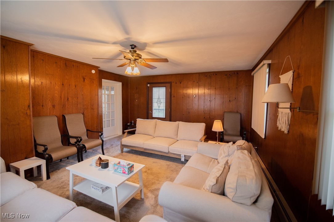 1118 Shields Road Youngstown, OH 44511 - Photo 8 of 21 Family room with wooden walls, light carpet, and ceiling fan