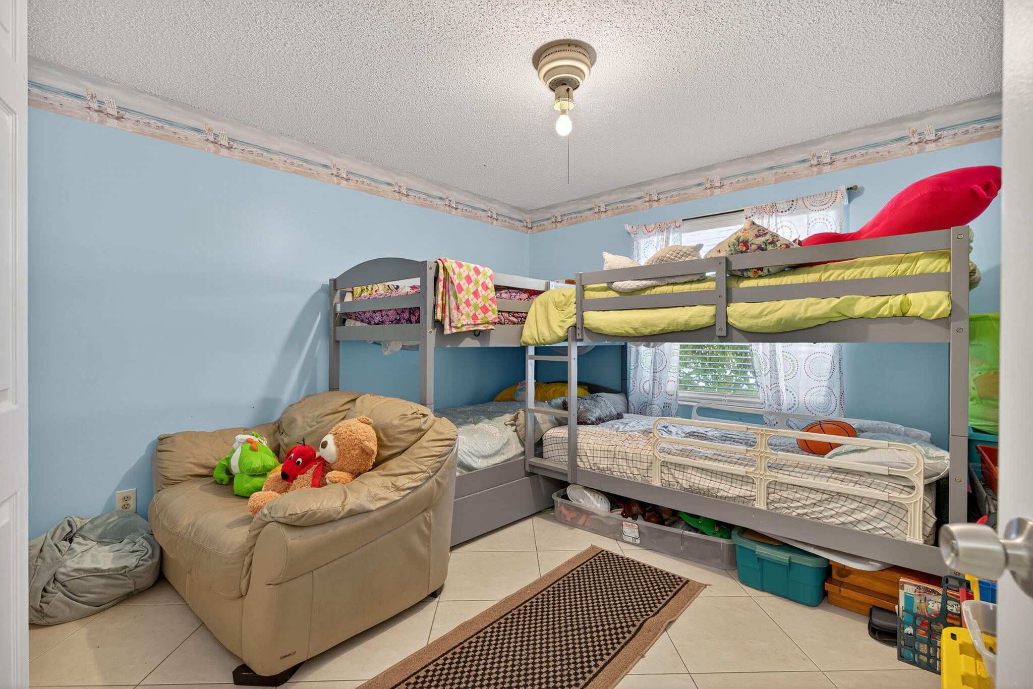 6877 3rd Street Jupiter, FL 33458 - Photo 12 of 25 a bedroom with furniture and a window