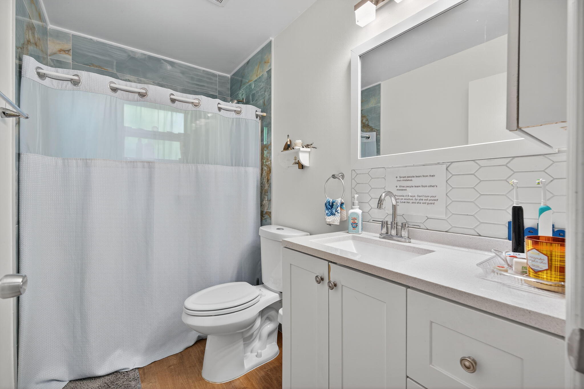 6877 3rd Street Jupiter, FL 33458 - Photo 14 of 25 a bathroom with a sink a toilet and shower