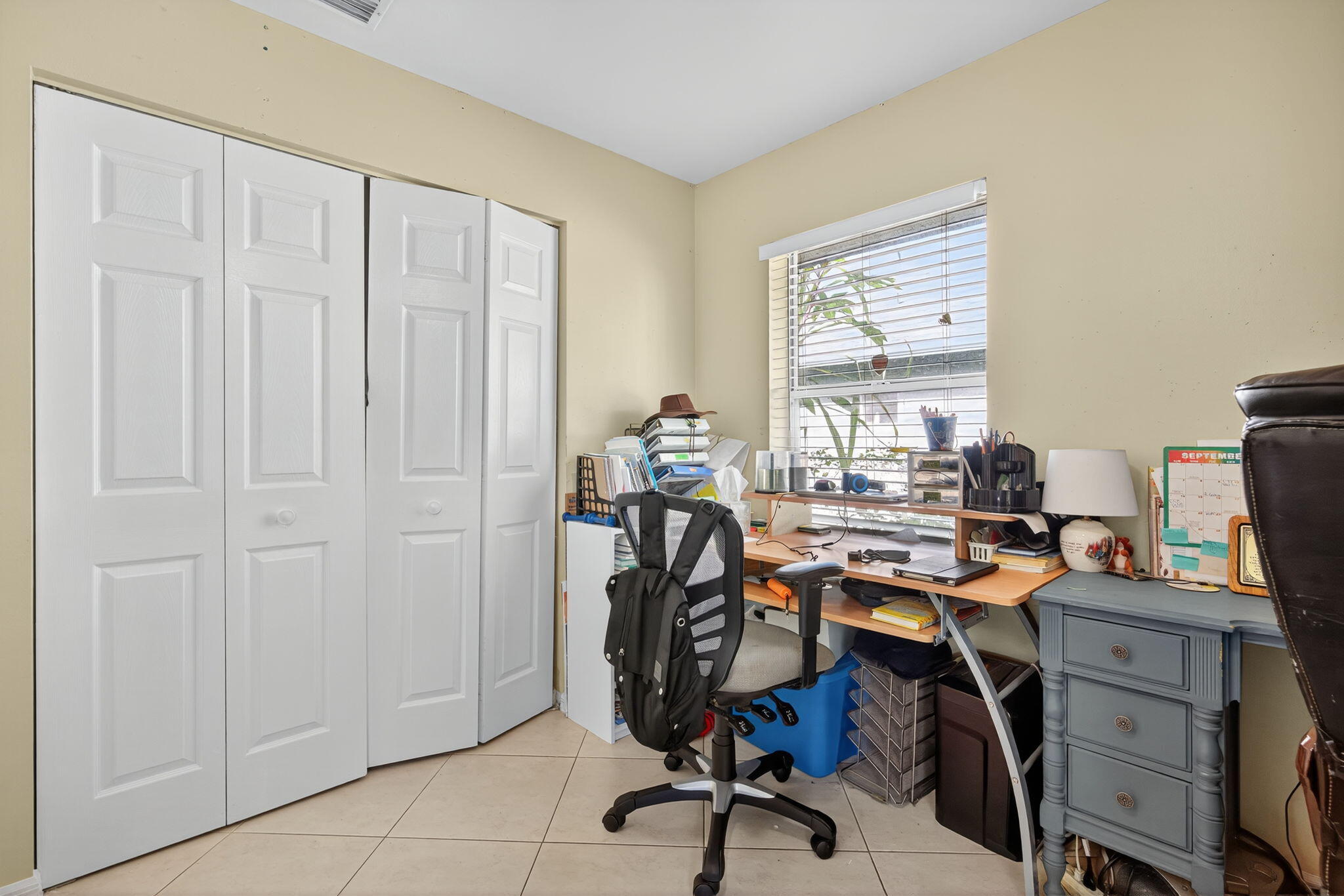 6877 3rd Street Jupiter, FL 33458 - Photo 16 of 25 a view of a workspace with furniture and a window