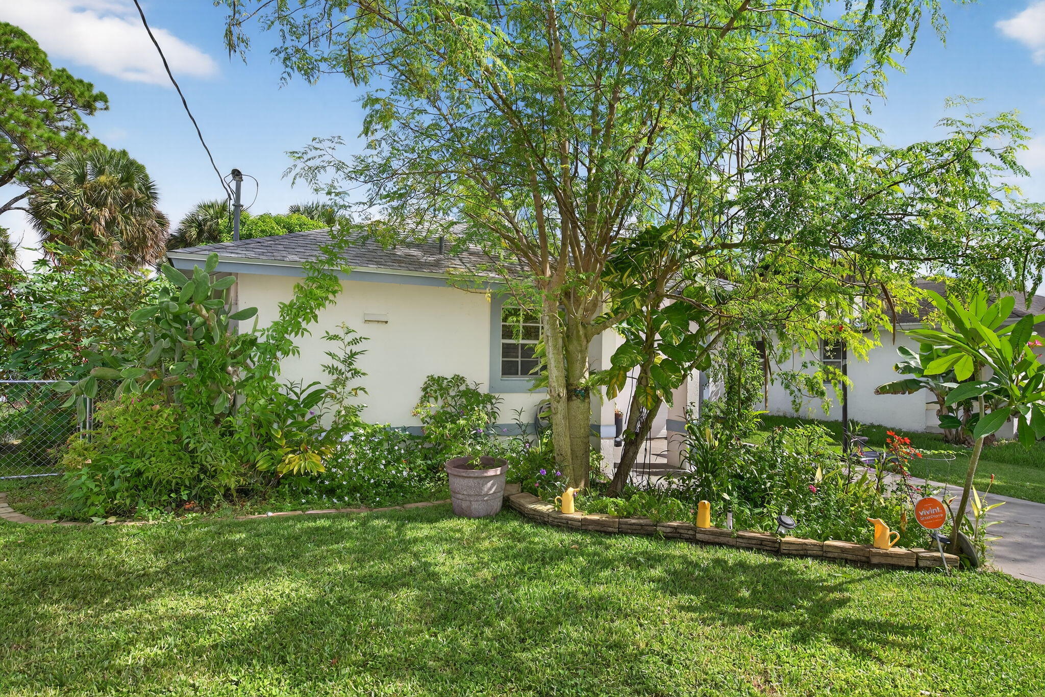 6877 3rd Street Jupiter, FL 33458 - Photo 18 of 25 a view of a house with a yard and plants