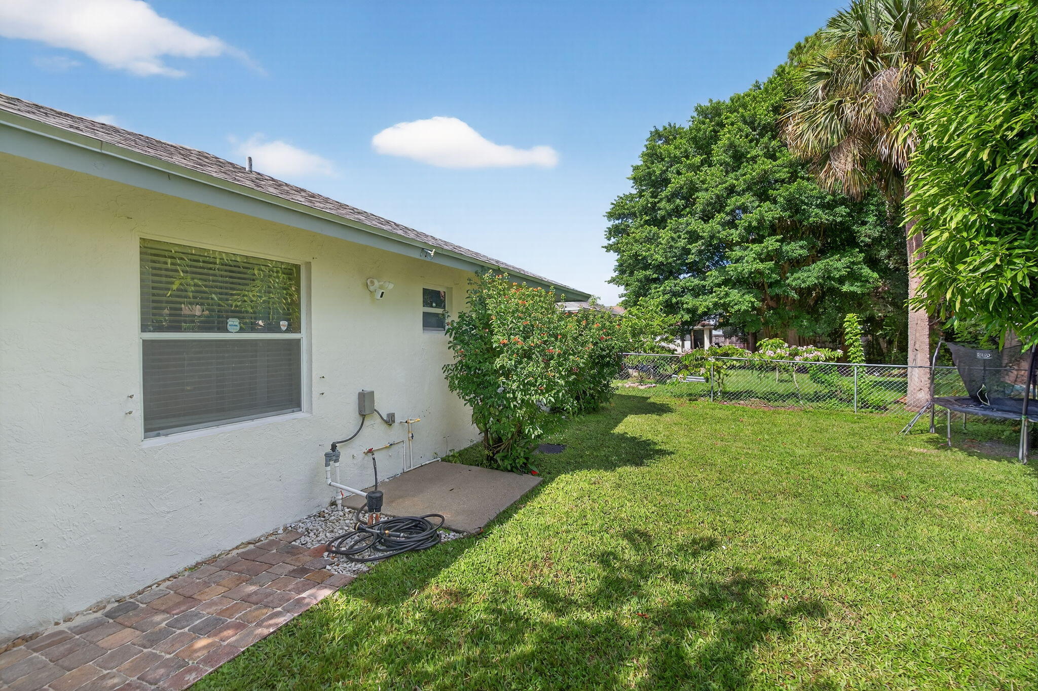 6877 3rd Street Jupiter, FL 33458 - Photo 21 of 25 a view of an house with backyard space and garden