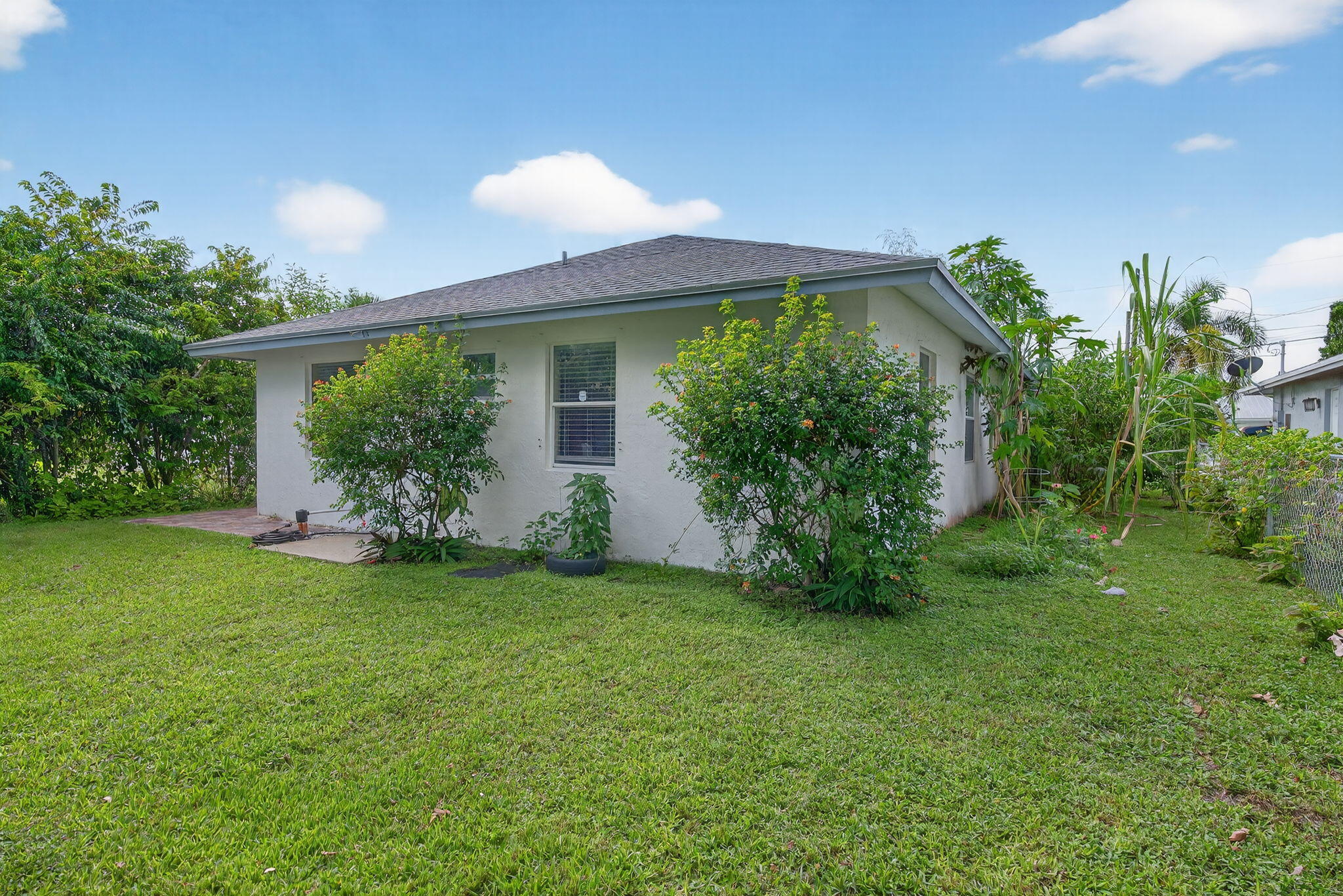 6877 3rd Street Jupiter, FL 33458 - Photo 22 of 25 front view of a house with a yard