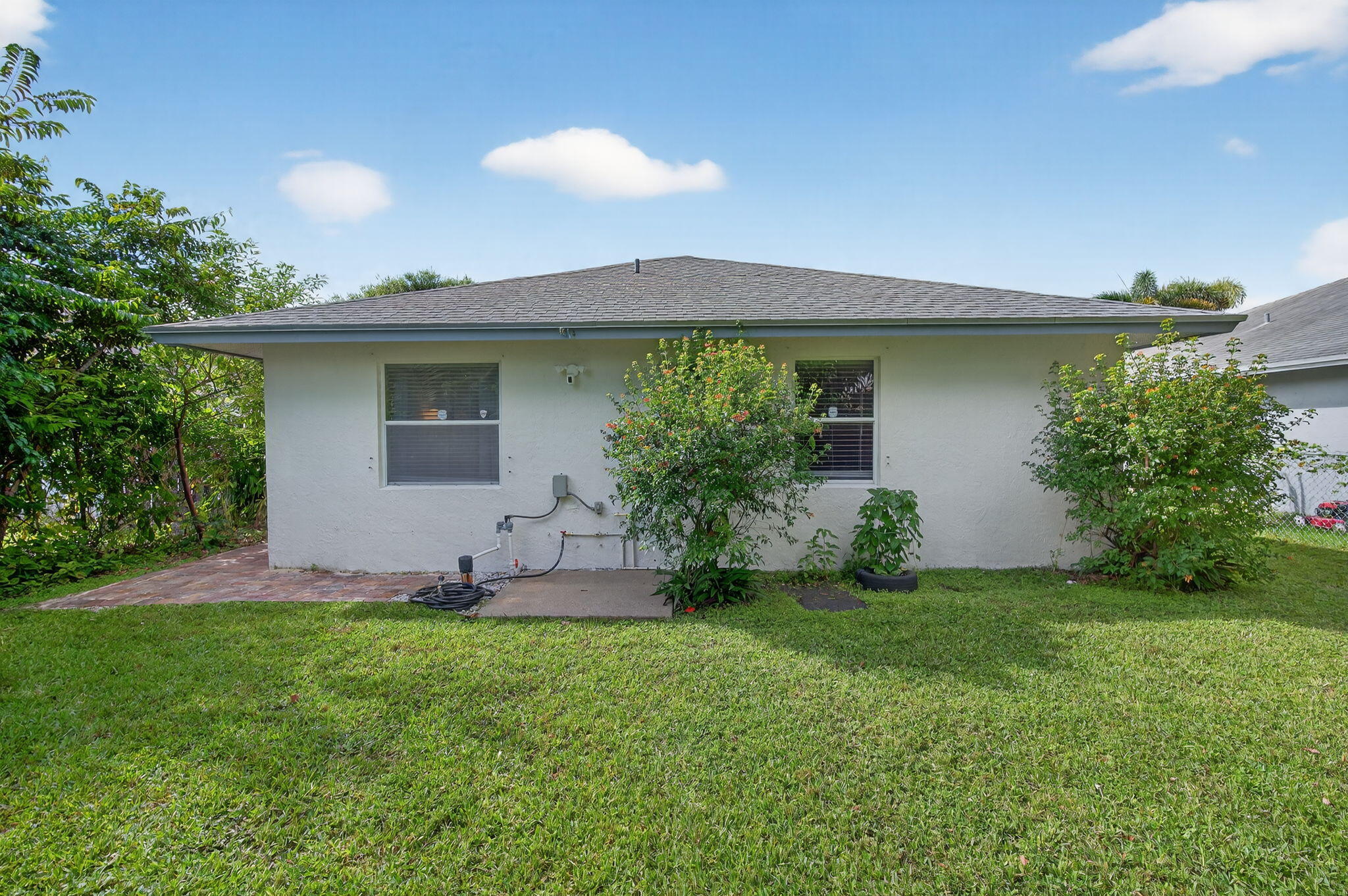 6877 3rd Street Jupiter, FL 33458 - Photo 23 of 25 a front view of house with yard and outdoor seating