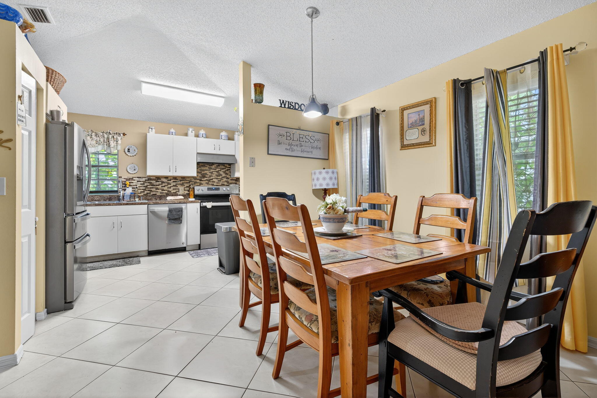 6877 3rd Street Jupiter, FL 33458 - Photo 4 of 25 a view of a dining room with furniture and a chandelier