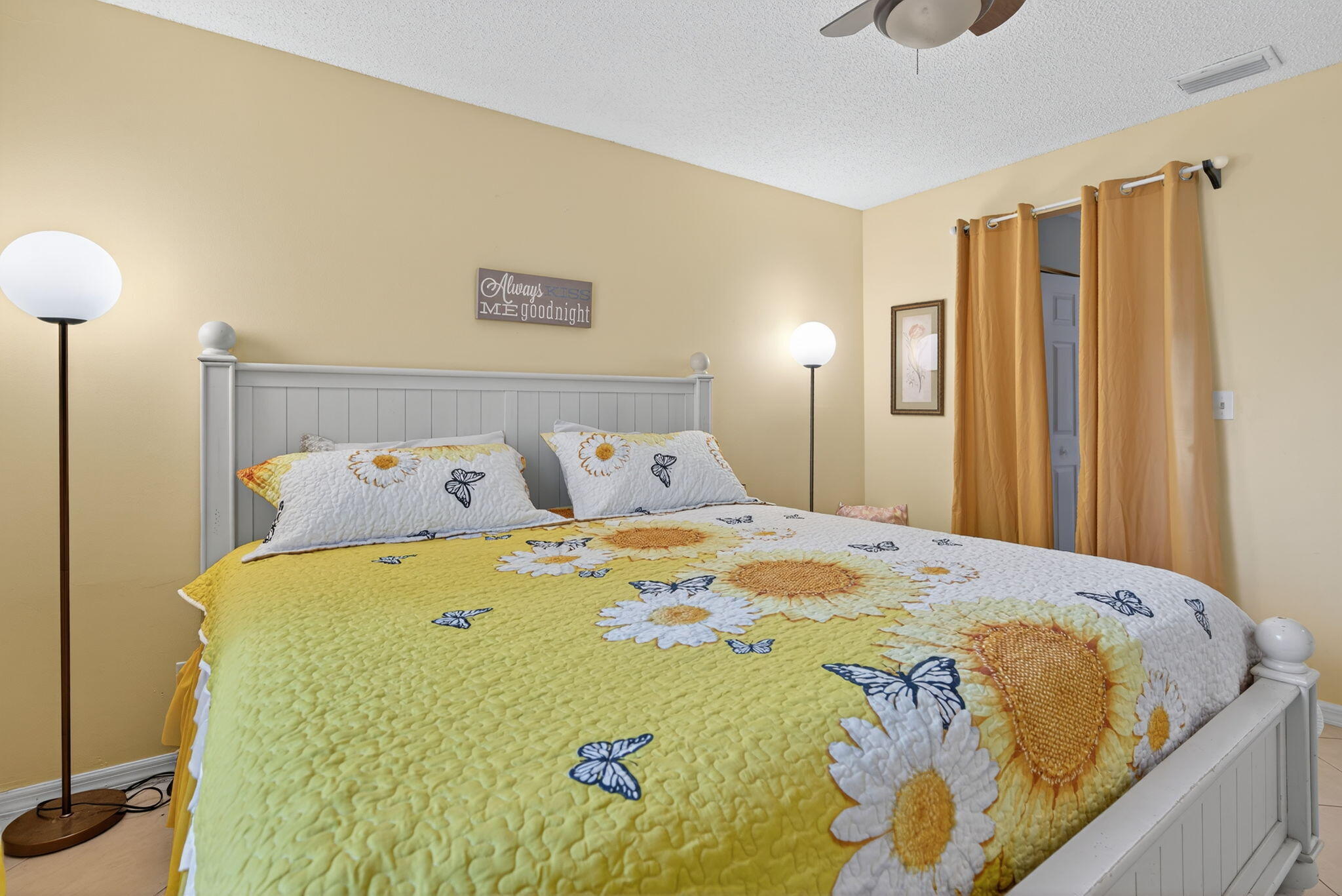 6877 3rd Street Jupiter, FL 33458 - Photo 7 of 25 a bed sitting in a bedroom next to a lamp