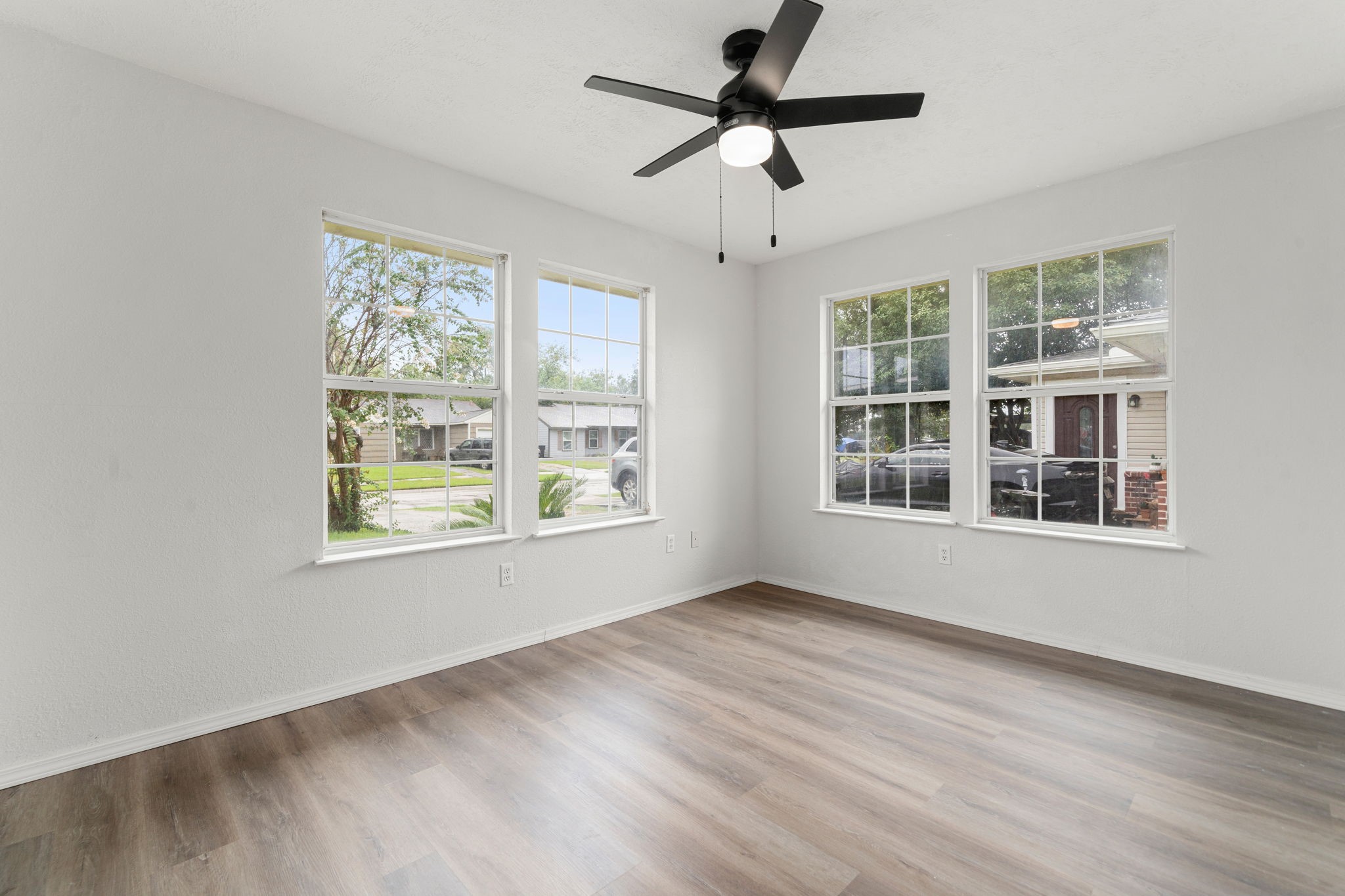 1206 Oak Meadows Street Houston, TX 77017 - Photo 12 of 32 a view of an empty room with a window and wooden floor