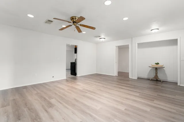 a view of empty room with wooden floor