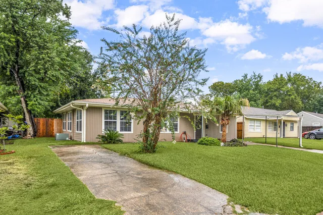 a front view of a house with a garden