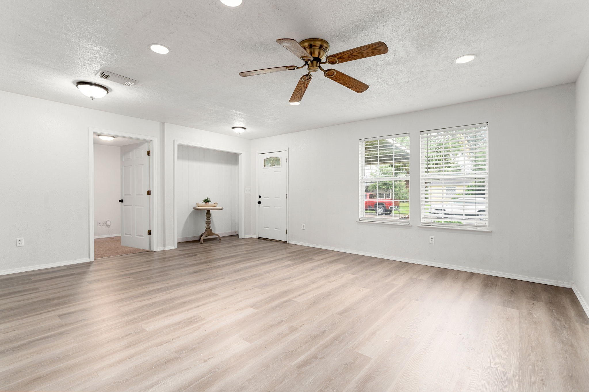 1206 Oak Meadows Street Houston, TX 77017 - Photo 3 of 32 a view of an empty room with a window and wooden floor