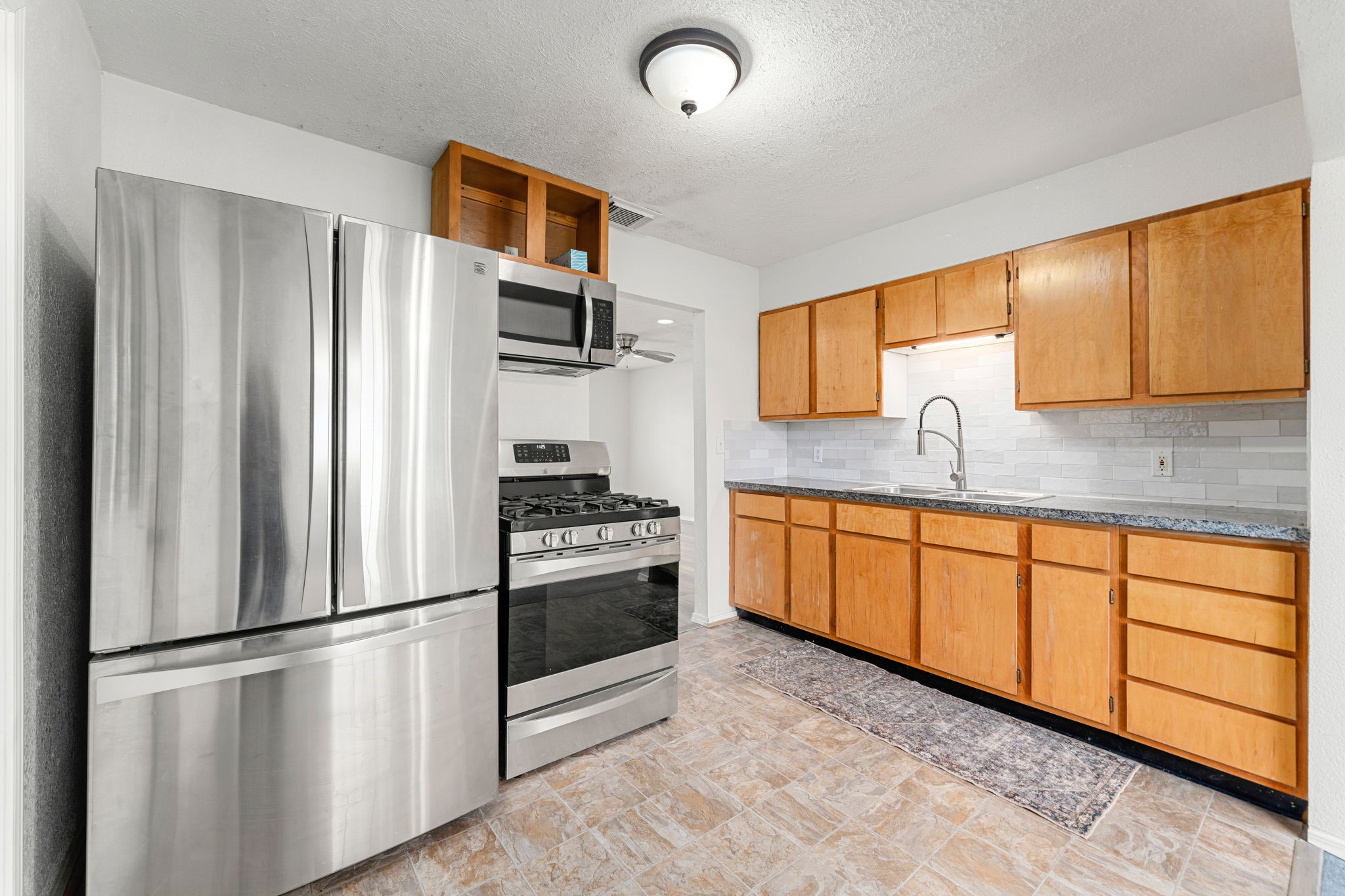 1206 Oak Meadows Street Houston, TX 77017 - Photo 6 of 32 a kitchen with stainless steel appliances granite countertop a refrigerator sink and stove