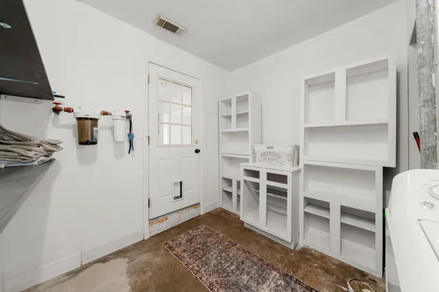 a view of a bedroom with furniture and window