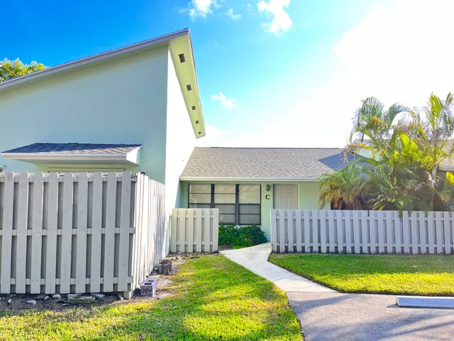 a view of a house with backyard and porch