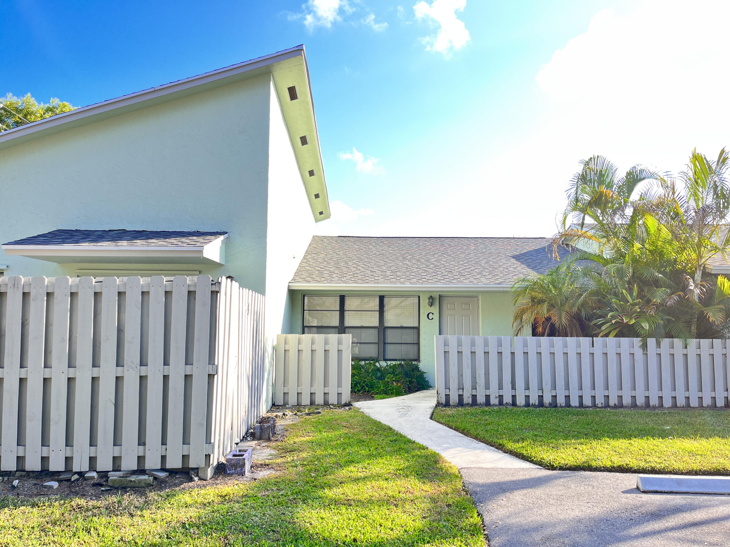 a view of a house with backyard and porch