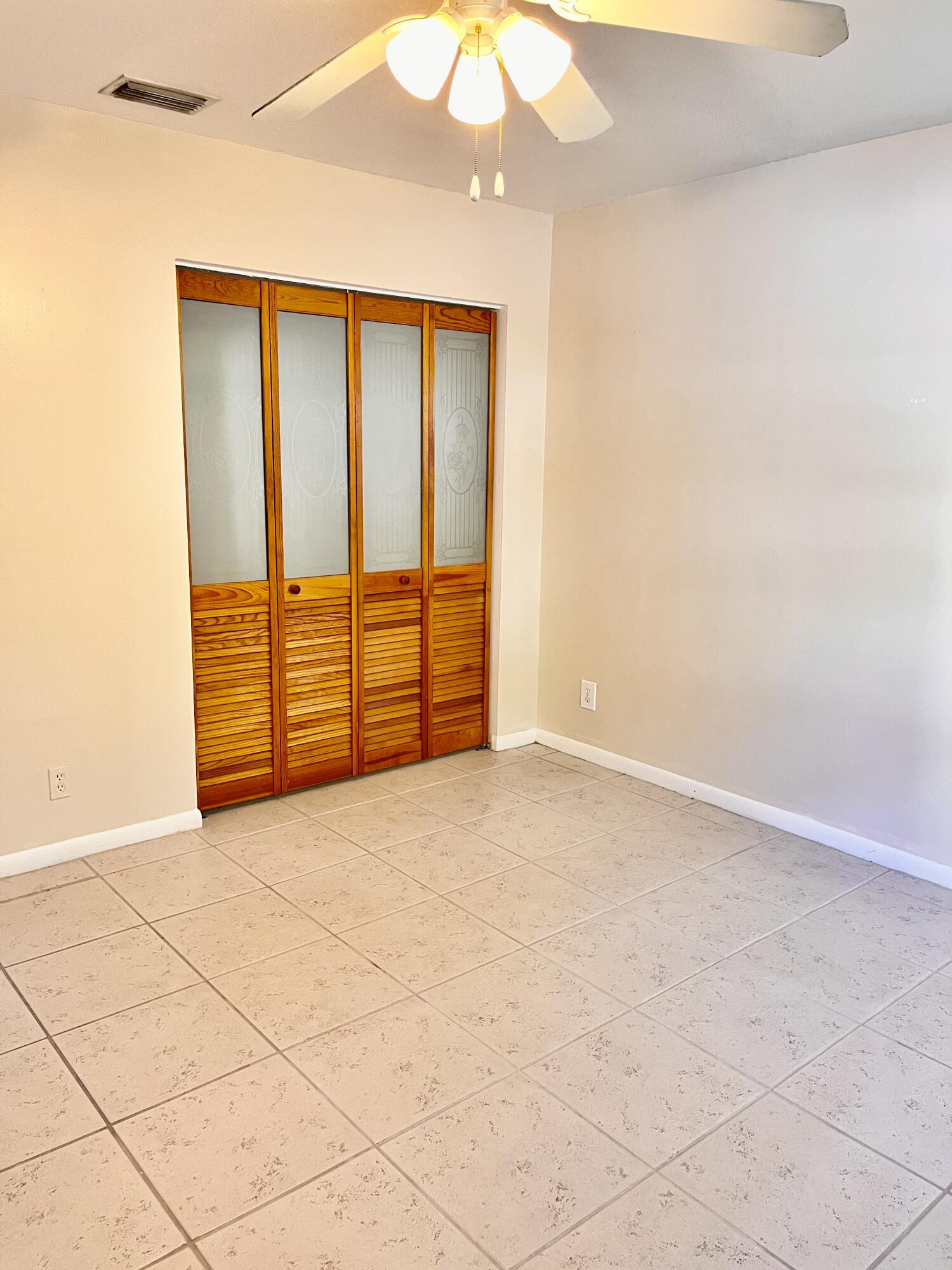431 Jupiter Lakes Boulevard, Unit 2104C Jupiter, FL 33458 - Photo 11 of 28 a view of an empty room with wooden floor