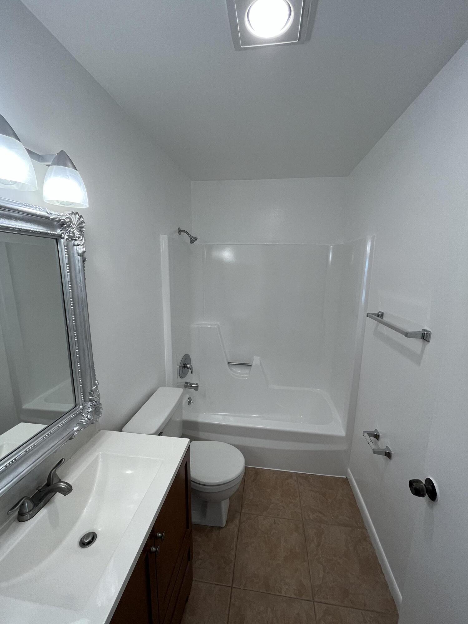431 Jupiter Lakes Boulevard, Unit 2104C Jupiter, FL 33458 - Photo 14 of 28 a bathroom with a sink a toilet and shower