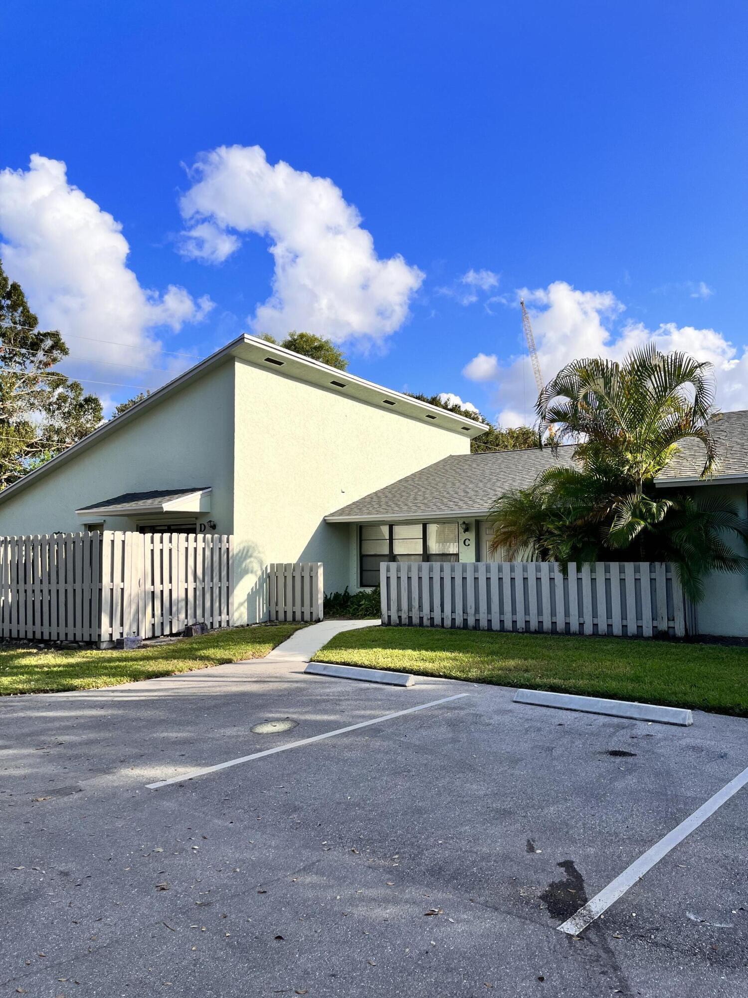 431 Jupiter Lakes Boulevard, Unit 2104C Jupiter, FL 33458 - Photo 17 of 28 a view of a big yard next to a house