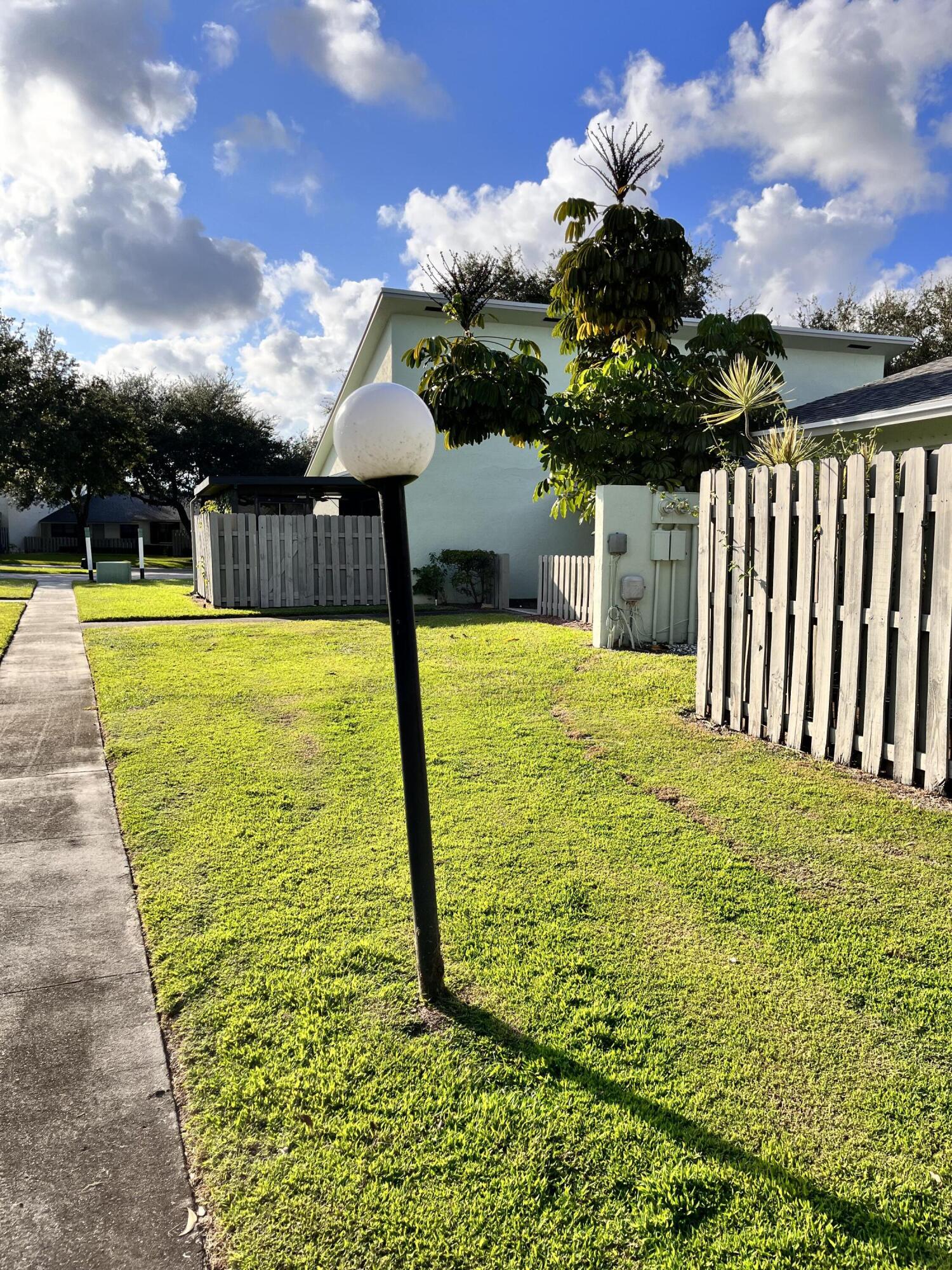 431 Jupiter Lakes Boulevard, Unit 2104C Jupiter, FL 33458 - Photo 20 of 28 a view of a swimming pool with an outdoor space and seating area