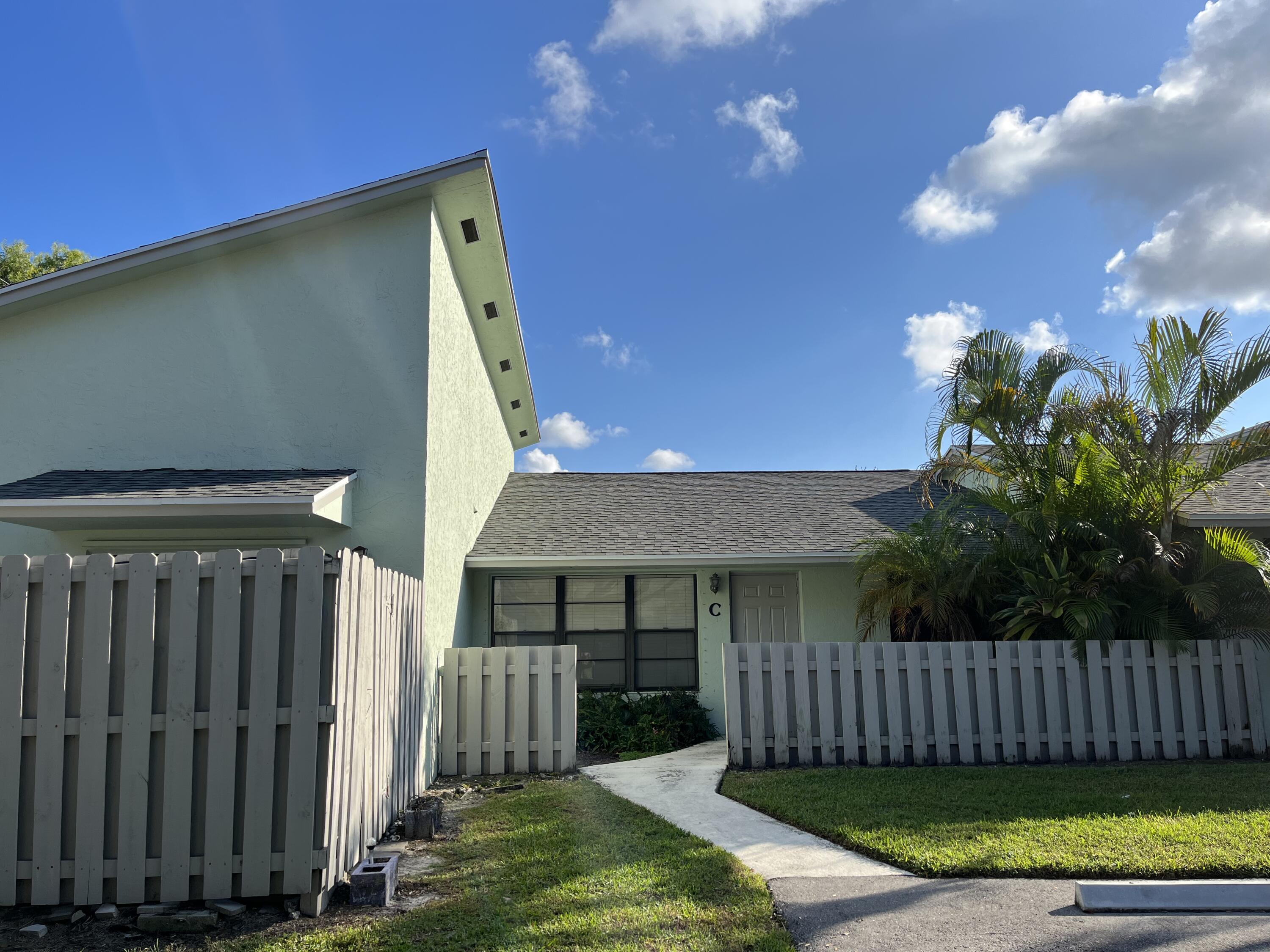 431 Jupiter Lakes Boulevard, Unit 2104C Jupiter, FL 33458 - Photo 26 of 28 a view of a house with a yard