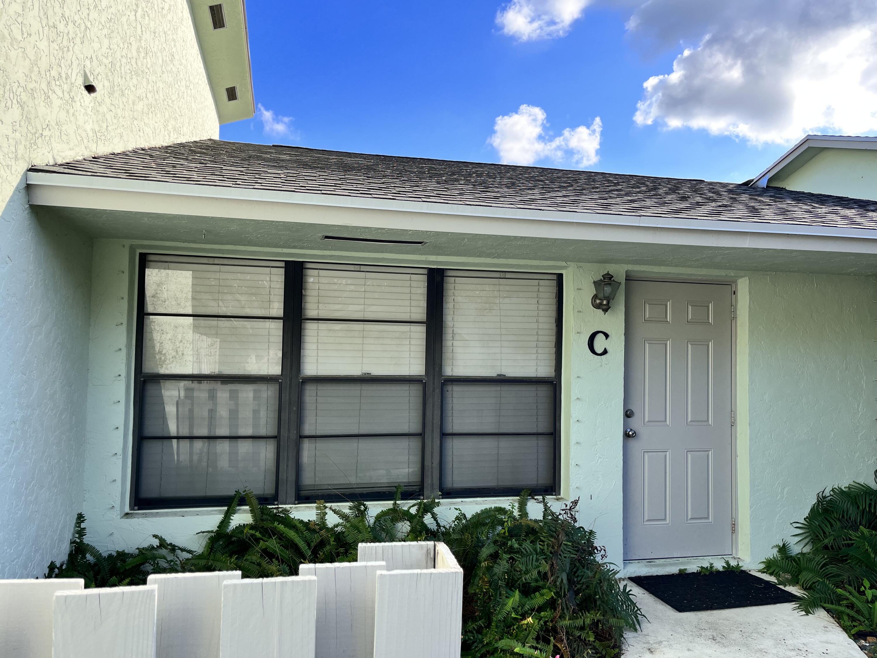 431 Jupiter Lakes Boulevard, Unit 2104C Jupiter, FL 33458 - Photo 27 of 28 a view of a potted plants in front of a house
