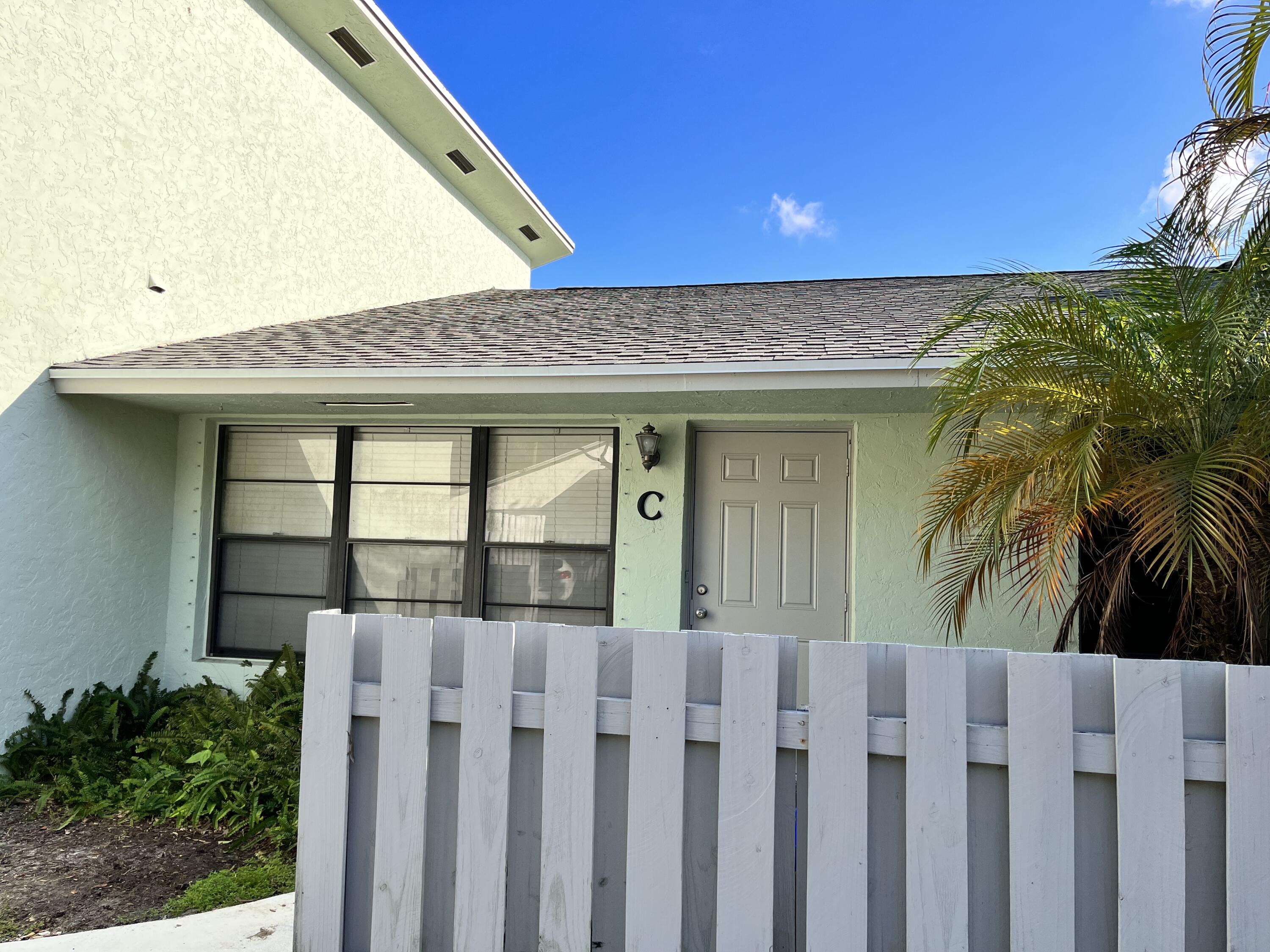 431 Jupiter Lakes Boulevard, Unit 2104C Jupiter, FL 33458 - Photo 28 of 28 a front view of a house with a garage
