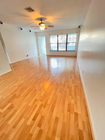 a view of a room with wooden floor