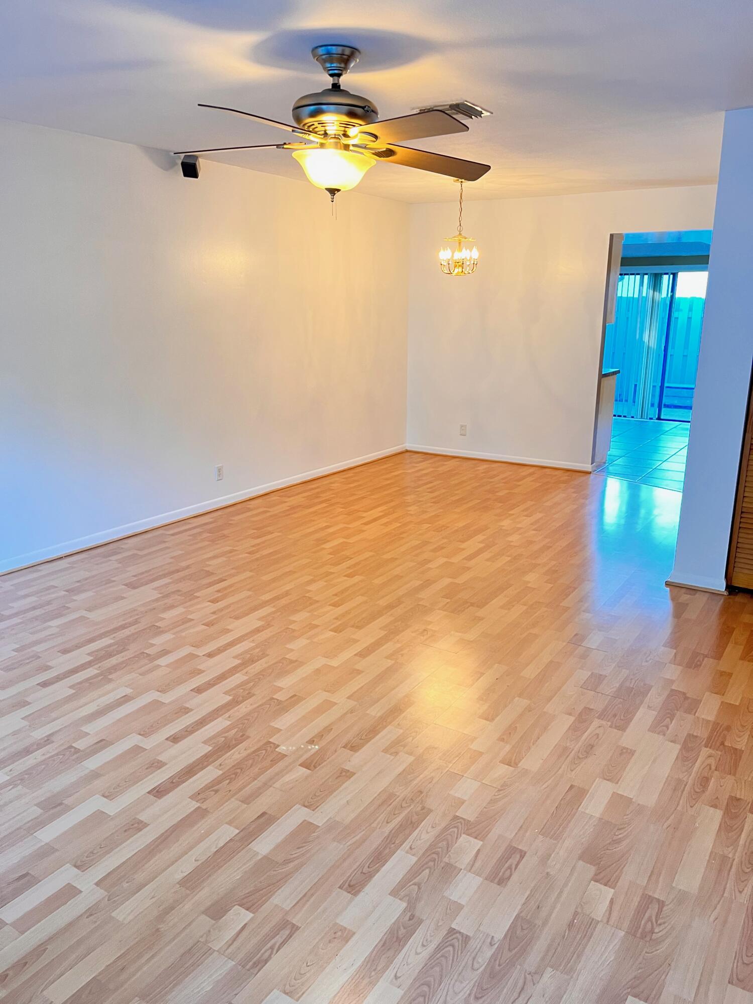 431 Jupiter Lakes Boulevard, Unit 2104C Jupiter, FL 33458 - Photo 4 of 28 a view of empty room with wooden floor