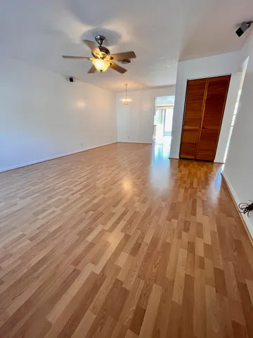 a view of an empty room with wooden floor