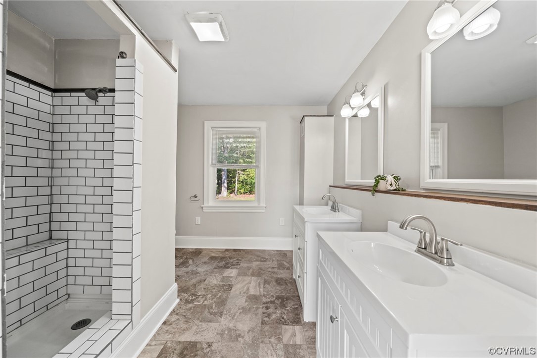 10121 Highview Road Glen Allen, VA 23059 - Photo 15 of 24 Bathroom featuring tiled shower, dual vanity, and