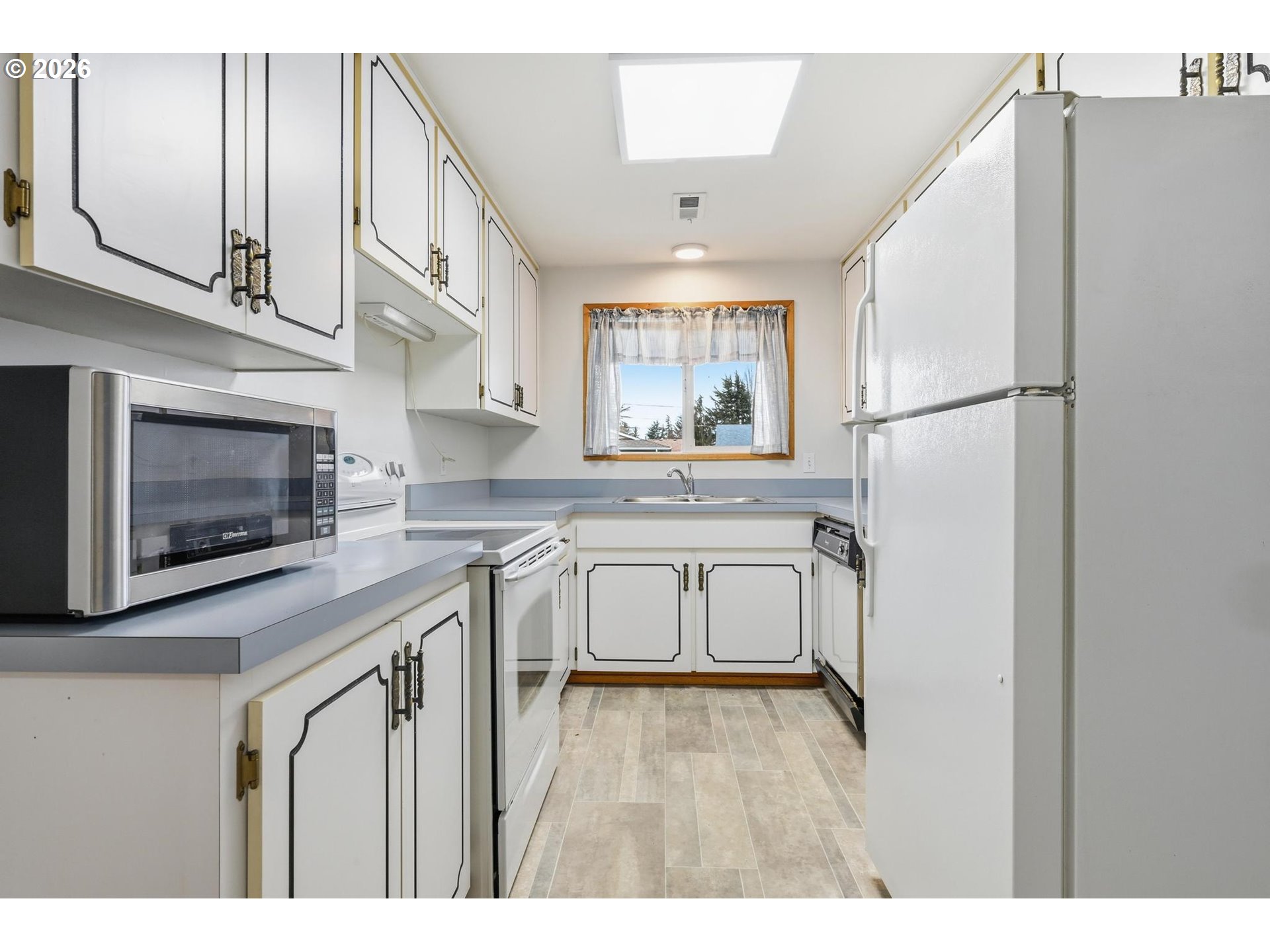 1720 Jansen Way Woodburn, OR 97071 - Photo 13 of 42 a kitchen with stainless steel appliances a refrigerator a stove a sink cabinets and a counter top space