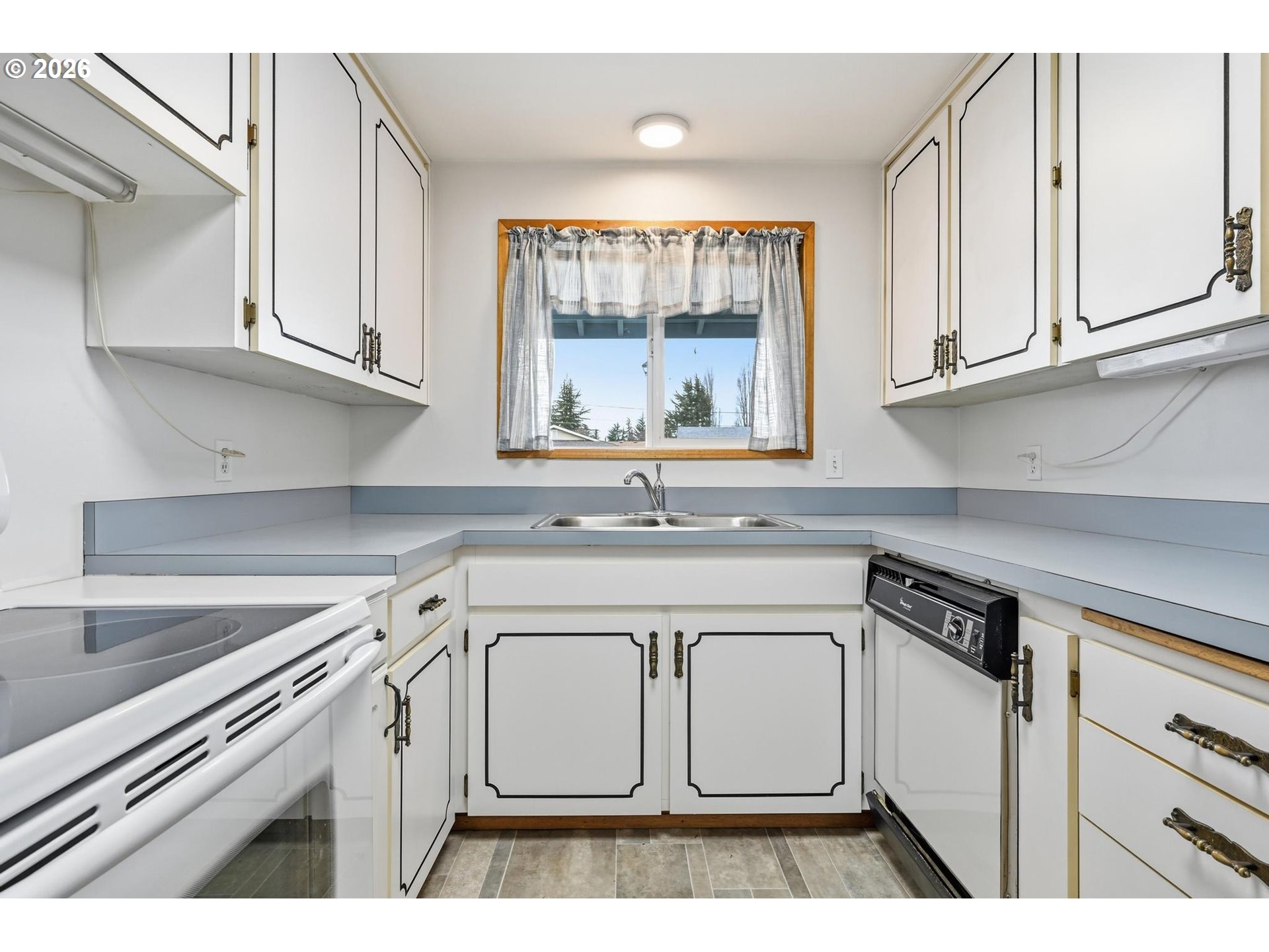 1720 Jansen Way Woodburn, OR 97071 - Photo 14 of 42 a kitchen with granite countertop white cabinets and white appliances