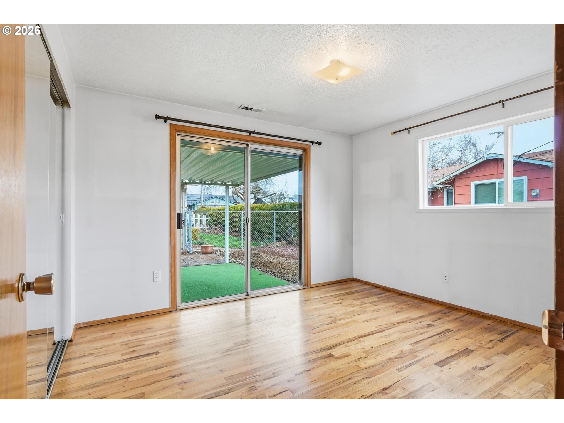 1720 Jansen Way Woodburn, OR 97071 - Photo 27 of 42 a view of an empty room with wooden floor and a window