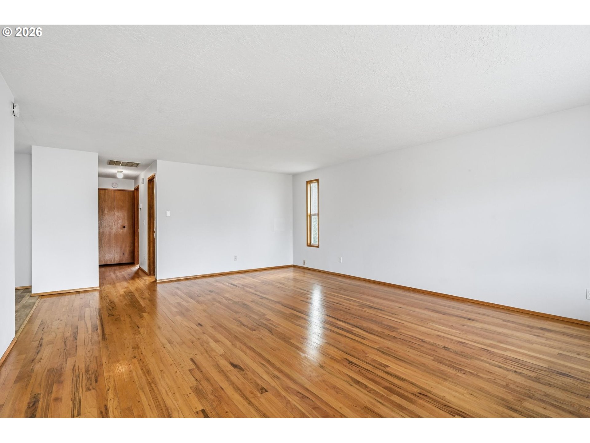 1720 Jansen Way Woodburn, OR 97071 - Photo 5 of 42 a view of an empty room and wooden floor