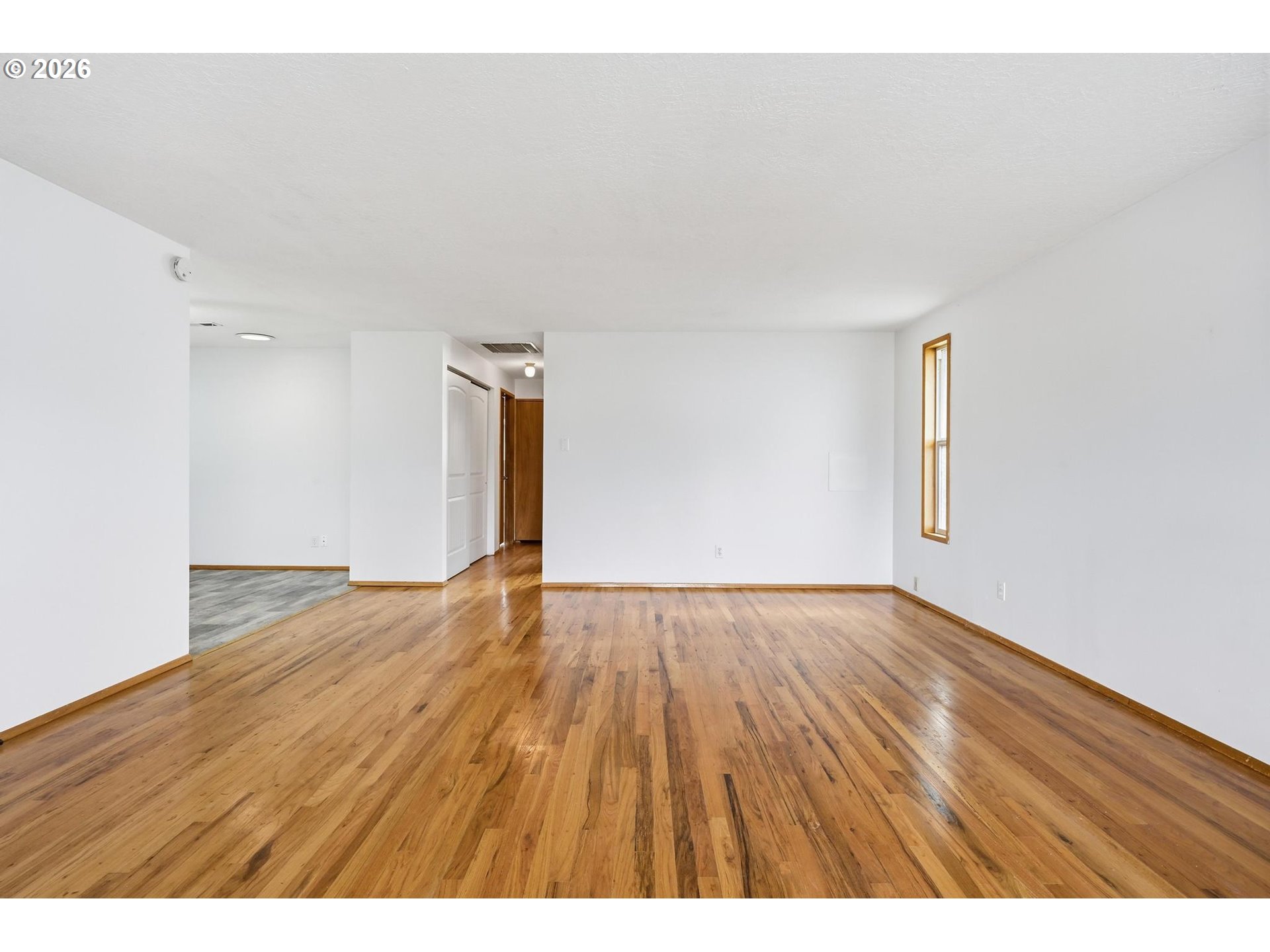 1720 Jansen Way Woodburn, OR 97071 - Photo 6 of 42 a view of an empty room and wooden floor