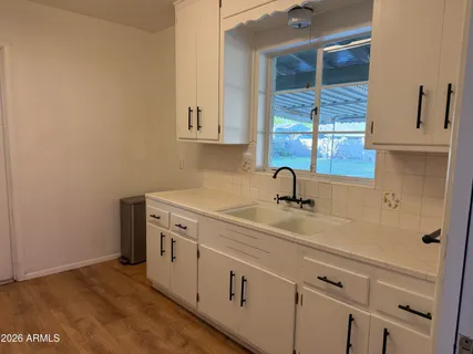a kitchen with a sink and cabinets