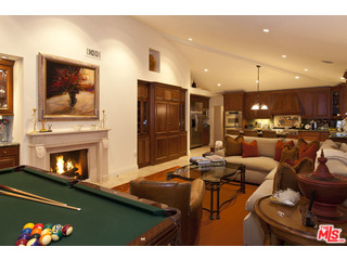 610 Estrellita Way Los Angeles, CA 90049 - Photo 19 of 53 a living room with fireplace furniture and a flat screen tv