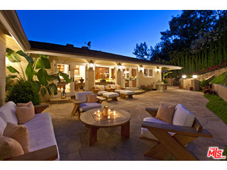 610 Estrellita Way Los Angeles, CA 90049 - Photo 3 of 53 a view of a patio with dining table and chairs with a fire pit