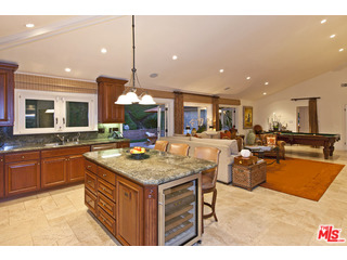 610 Estrellita Way Los Angeles, CA 90049 - Photo 21 of 53 a kitchen with stainless steel appliances granite countertop a kitchen island a stove and a sink